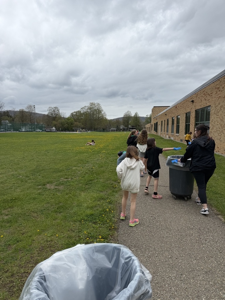students outside cleaning on the sidewalk