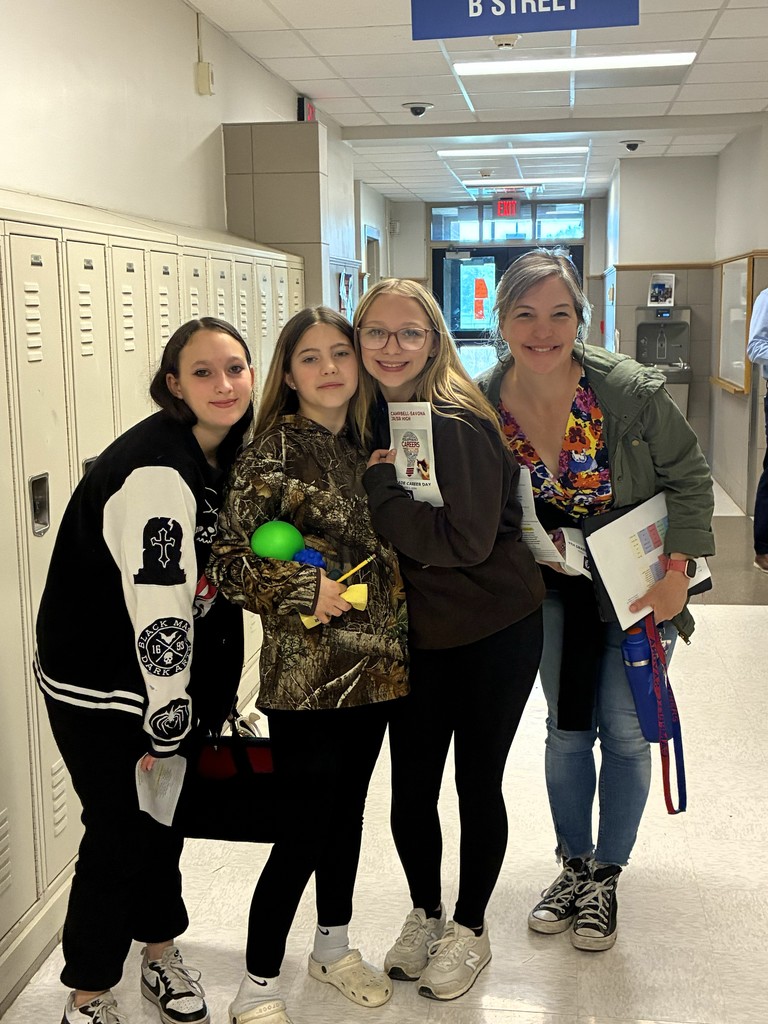 Teacher with students posing at career fair