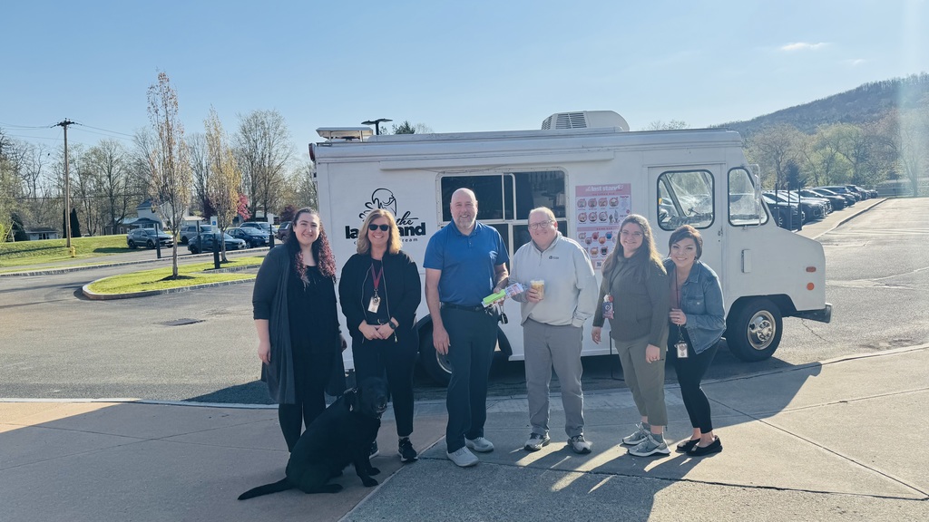 Group photo of teachers standing in front of last stand ice cream truck