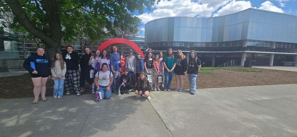 Group photo of students in front of Corning inc
