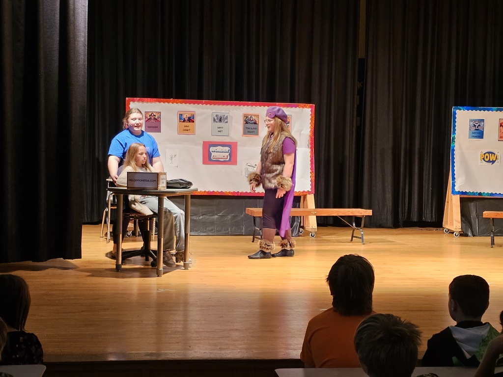 3 students on stage acting
