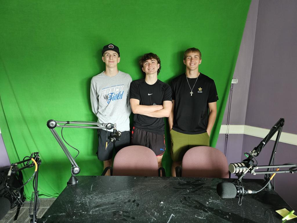 Three track athletes standing for picture