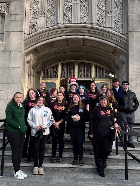 Group photo of seussical class outside theater