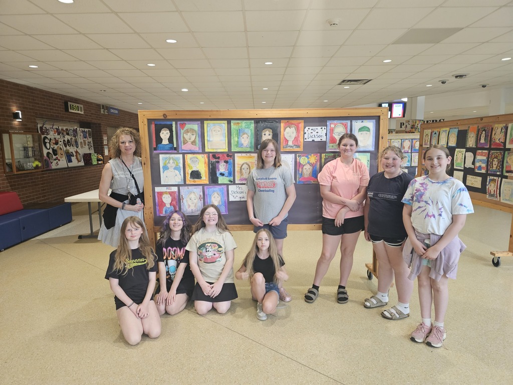 Group photo of students in front of art work