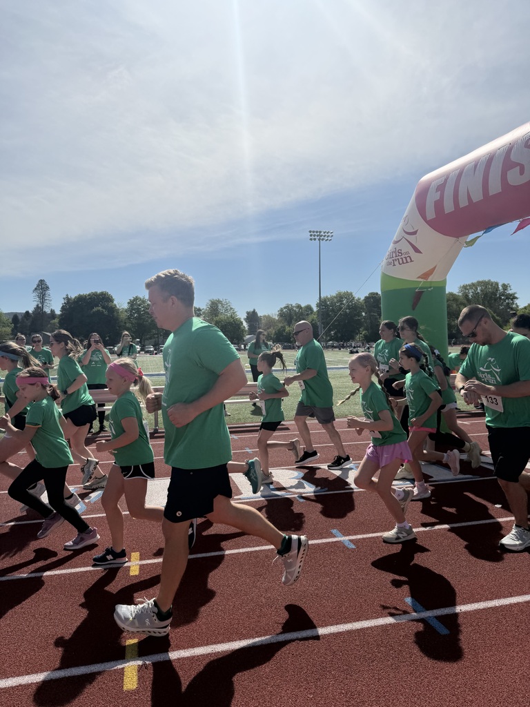 Runners in green shirts in the track