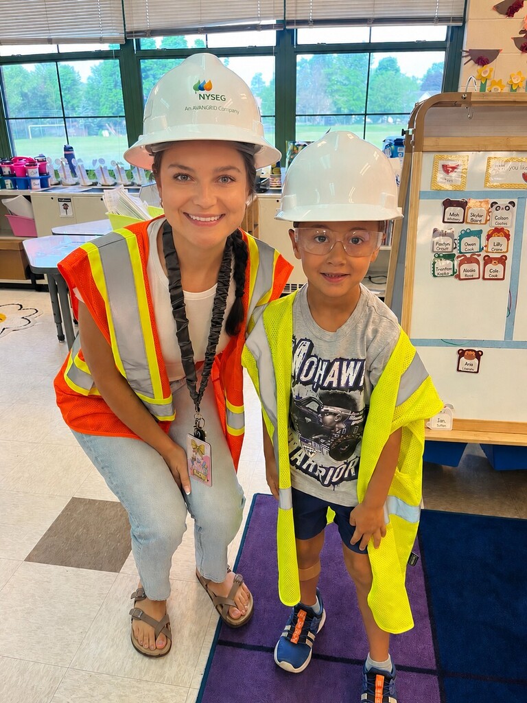 Teacher and student wearing construction vests