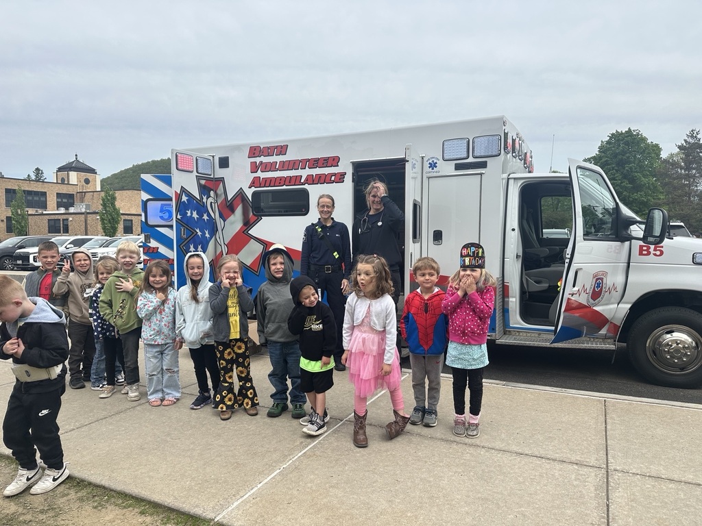 Students posing in front of ambulance