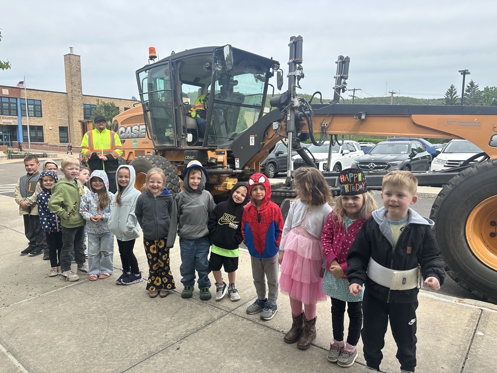 Group photo of studnets in front of  earth moving equipment