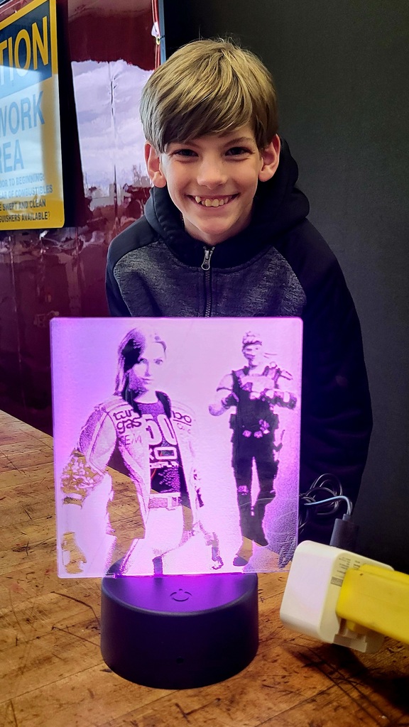 Student showing off a 3d glass picture.