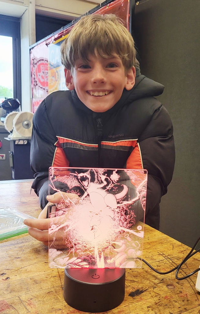 Student showing off a 3d glass picture.