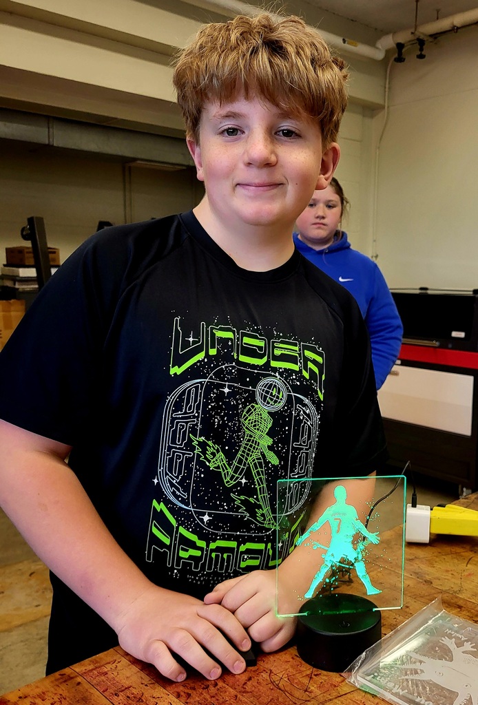Student showing off a 3d glass picture.