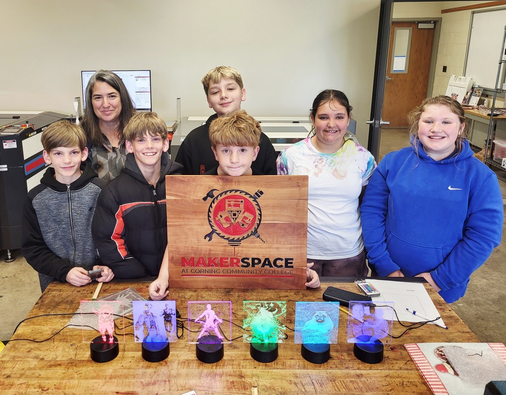 Group photo of the computer club holding a maker space sign
