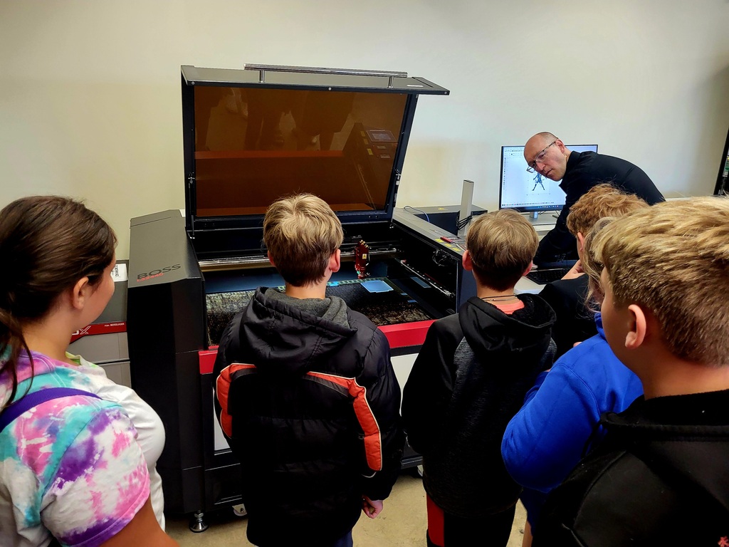 Group opf students looking at 3d printer