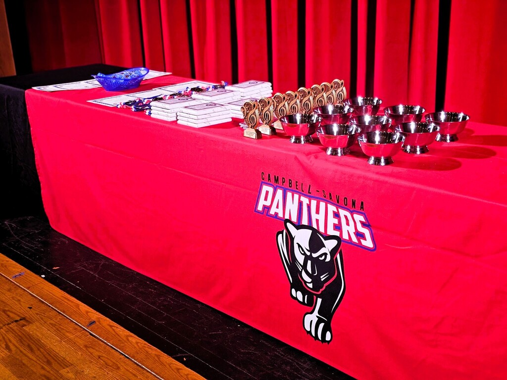 Award table with awards and school logo