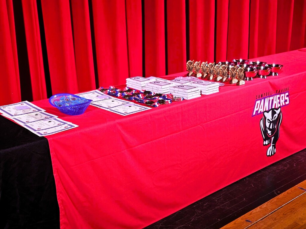 Award table with awards and school logo