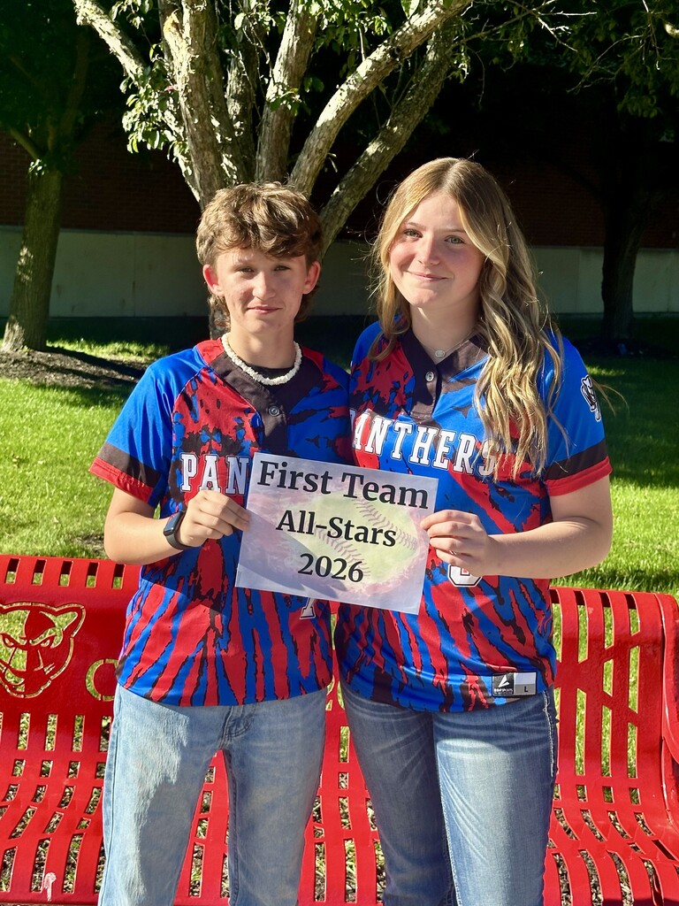 Two atheletes wearing panther school shirts and holding first eam all star sign