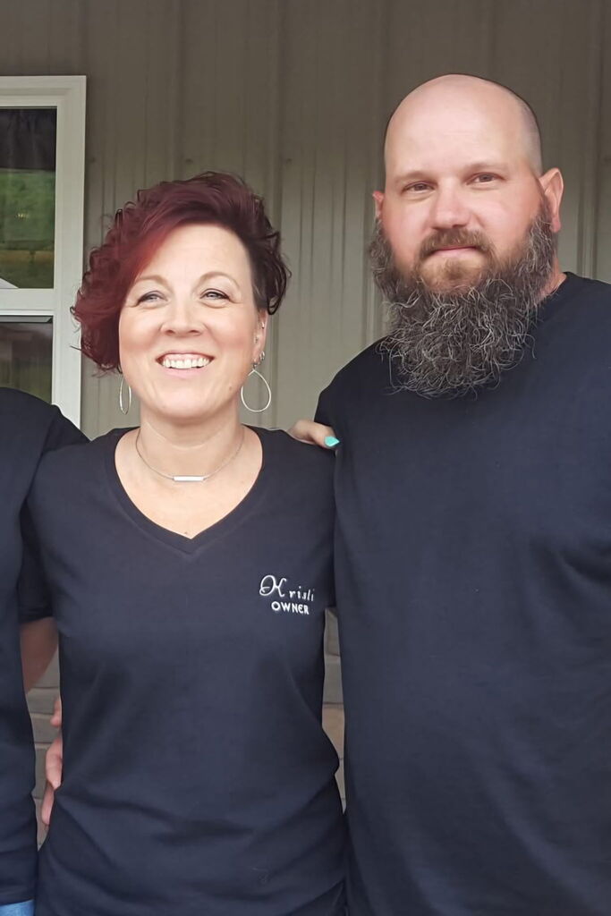 Girl and guy with beard in black shirts posing