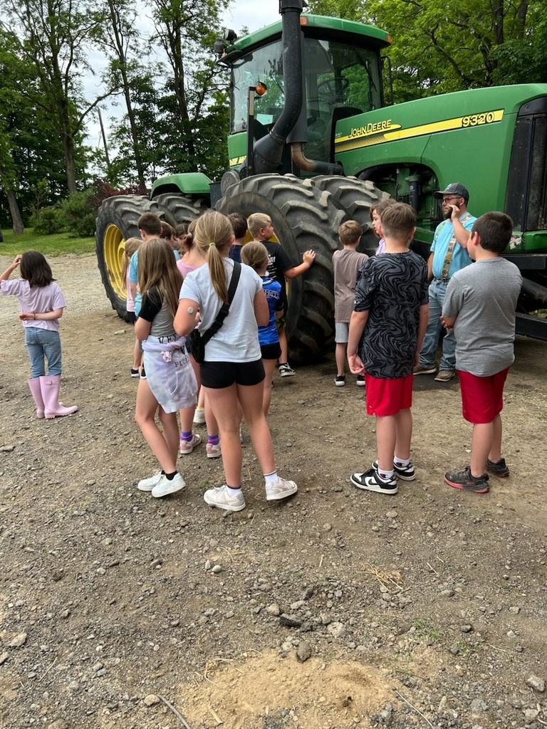 Students looking at big tractor