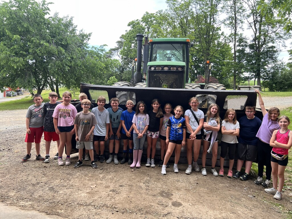 Group photo in front of tractor