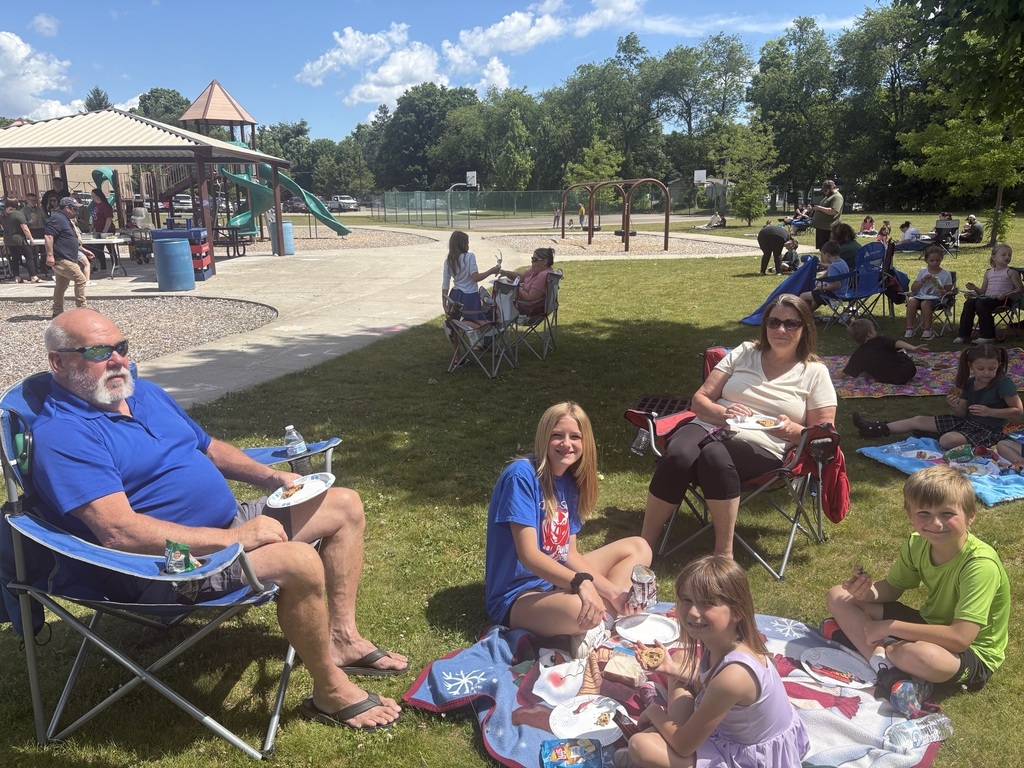 Faamily sitting outdoors for apicnic