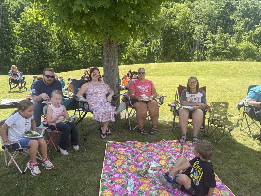 Family outside in picnic chairs