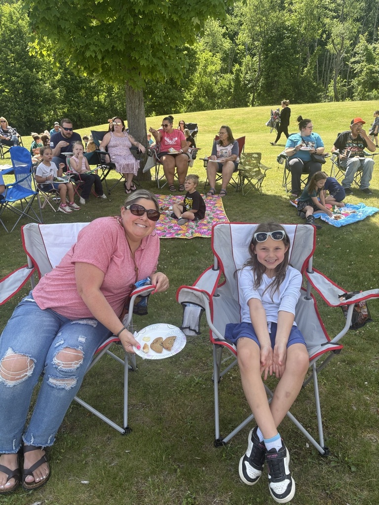Mother daughter smiling sitting outside for a picnic