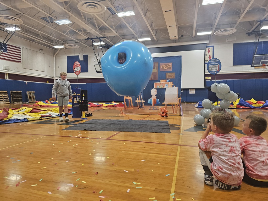 Adult in a big blue balloon jumping