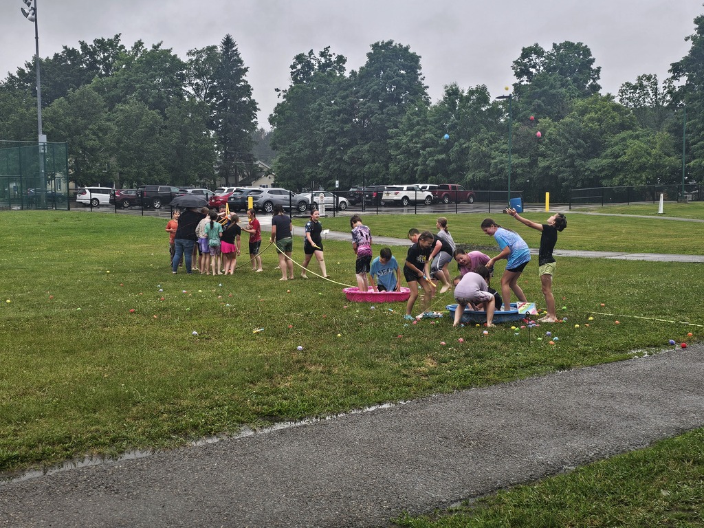 Students outside playing water games in the rain