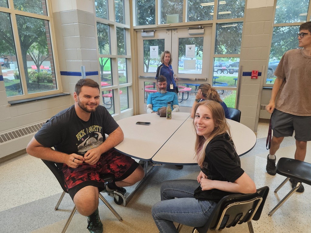 Two people sitting at cafeteria table
