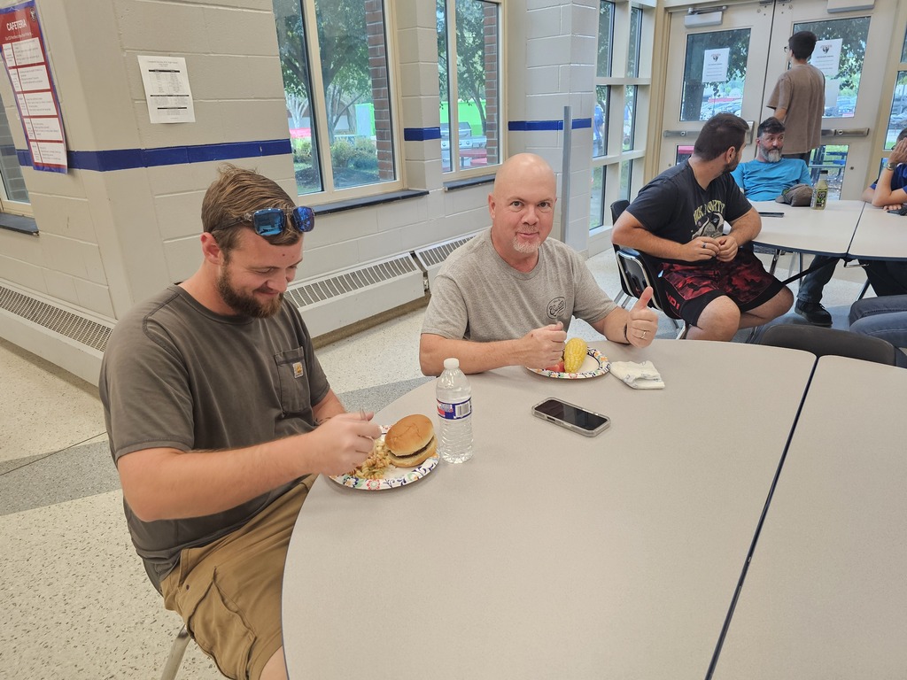 Two men sitting at table eating