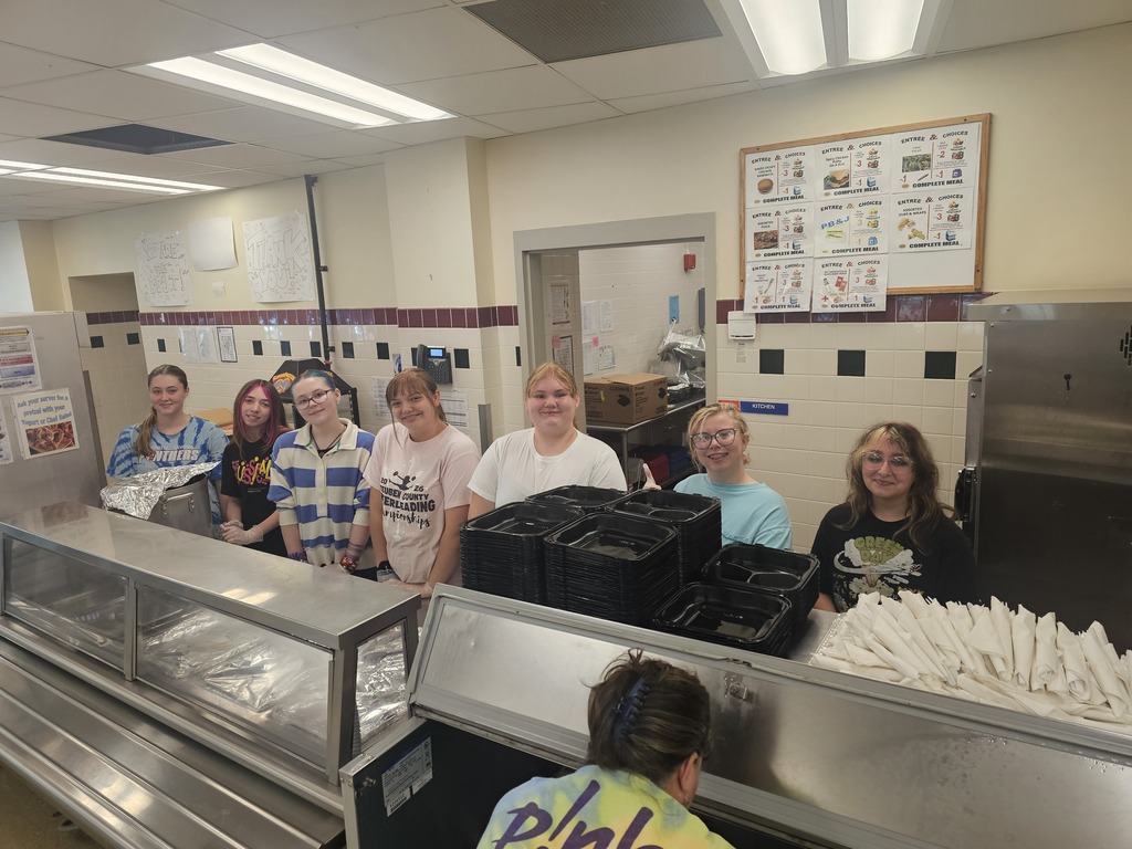 Students serving chicken dinners
