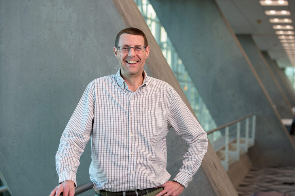 Man in collared shirt posing for picture