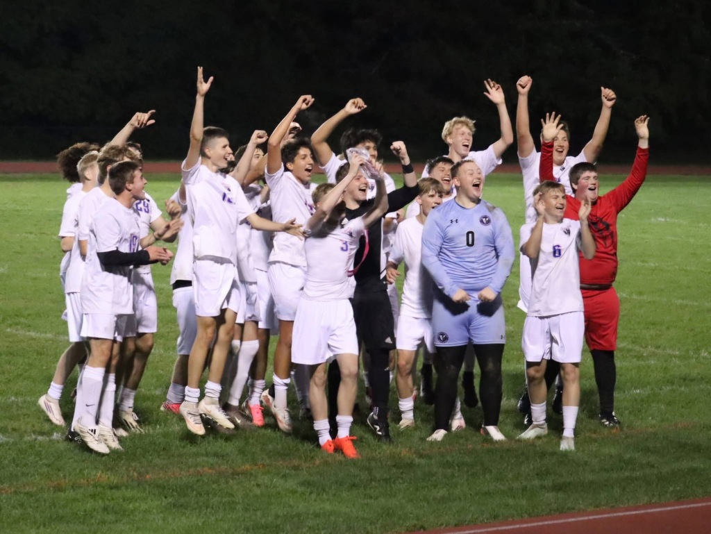 Boys soccer team celebrating on the field