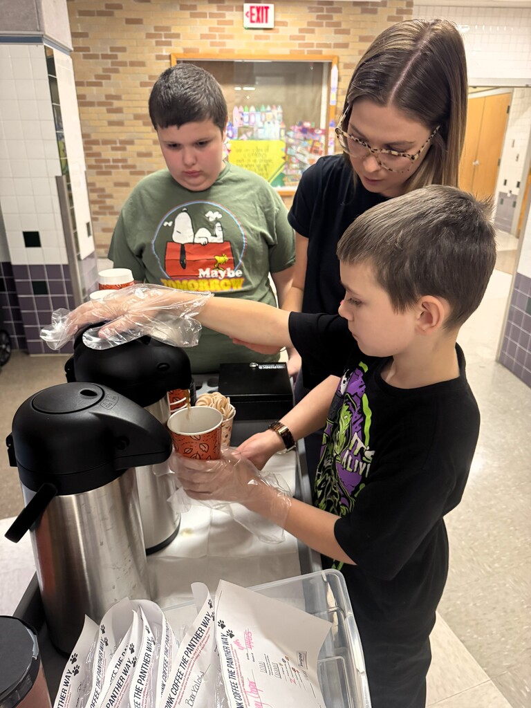 Kids pouring coffee out of a samavar