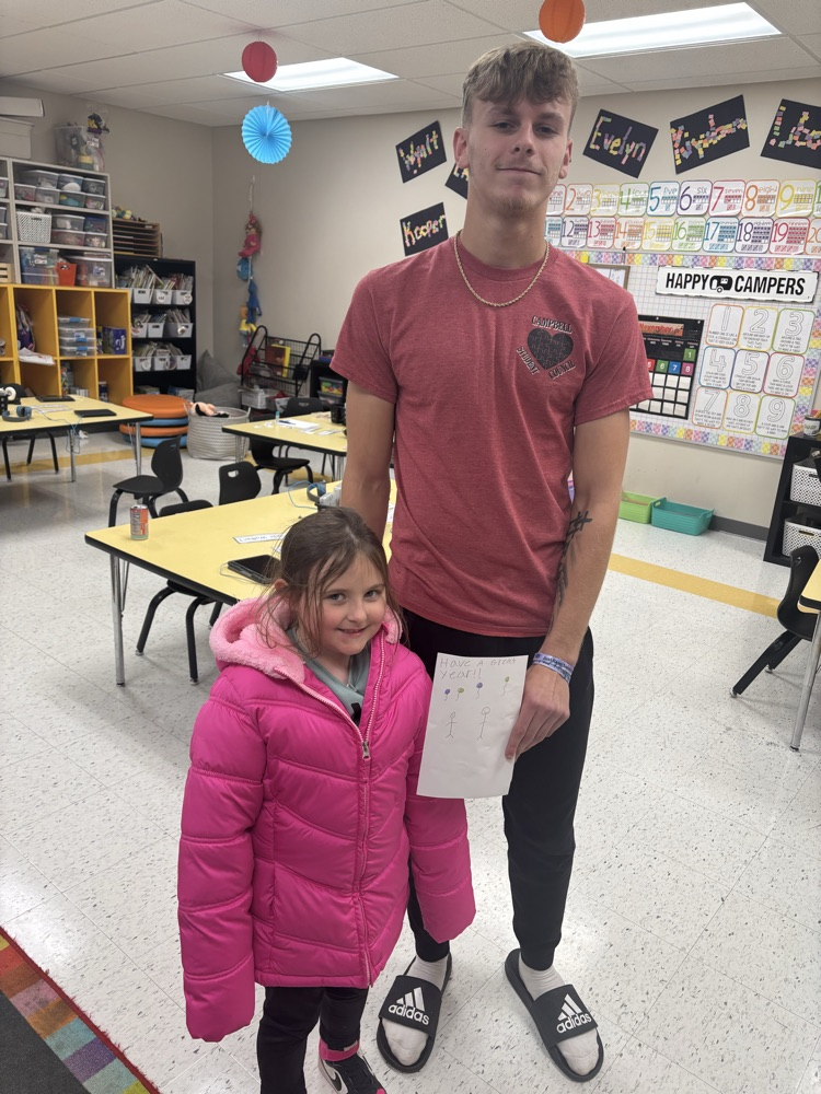 Caiden Mayberry with his kindergartener reading the card he made for her.