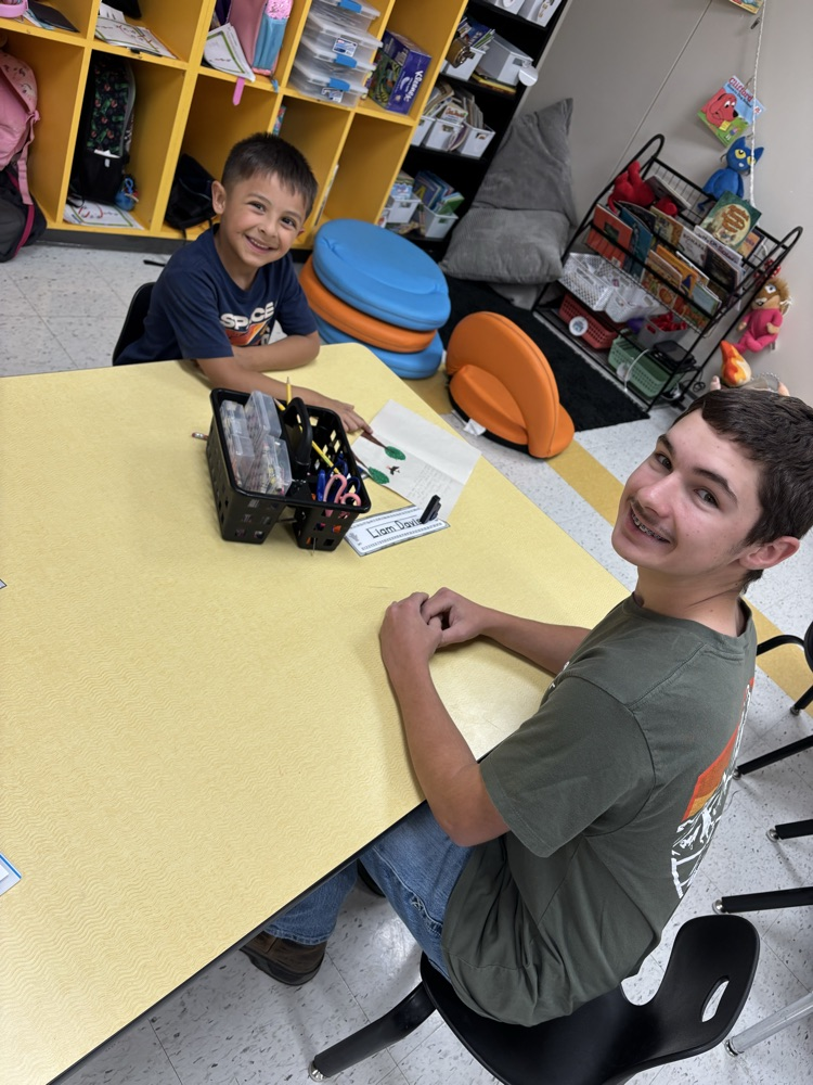 Collin Thompson and his kindergartener drawing together.