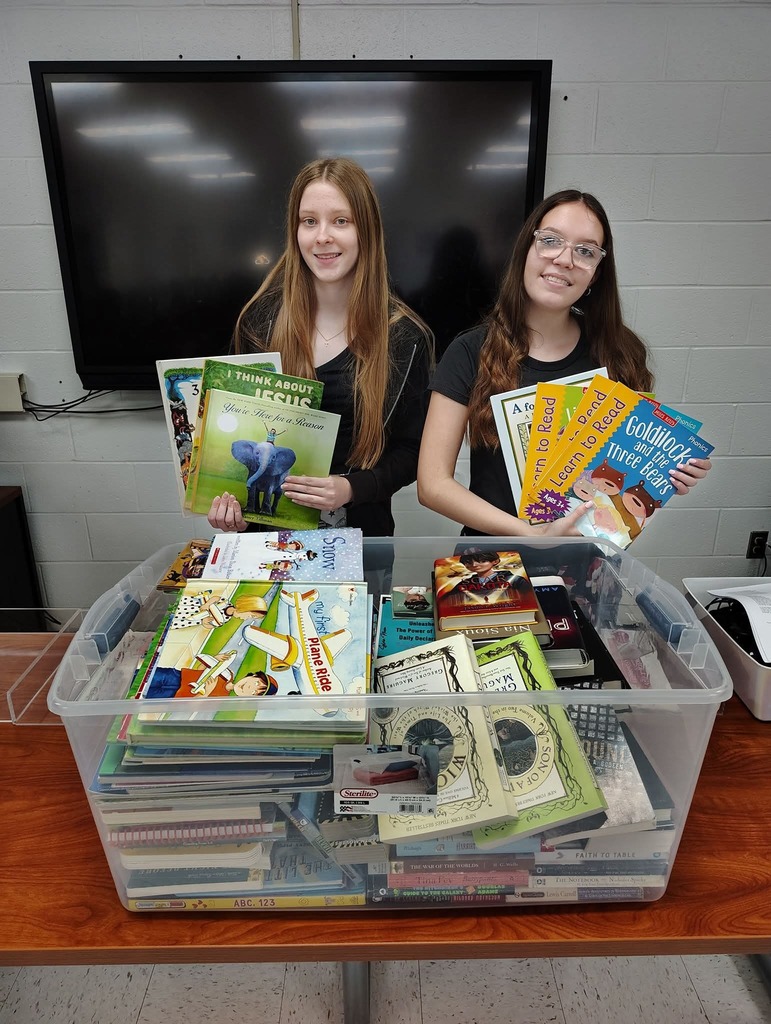 President Taylor Coleman and Vice President Rita-Joy Wheeler with book donations