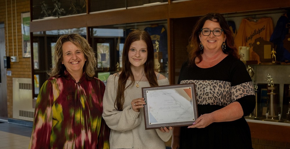 "Yes I Can" award recipient Isabelle Greene being presented a plaque from Becky Zingsheim with WICEC and Heidi Retzer (Teacher).