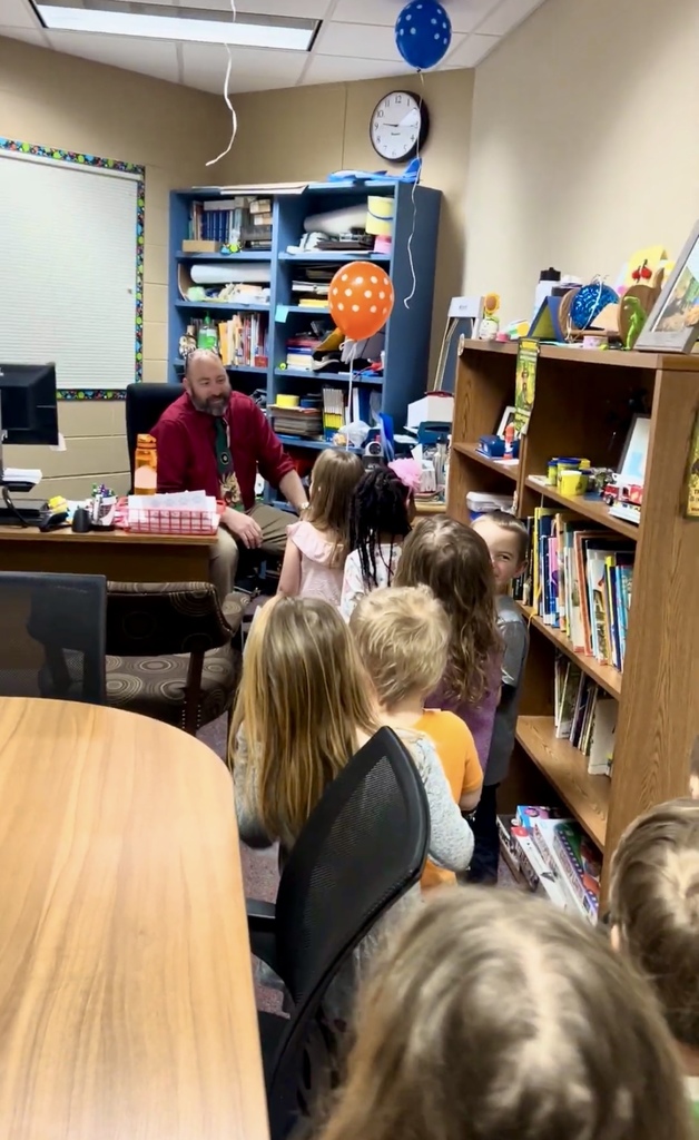 Students surprising Mr. Hamm with balloons and cards