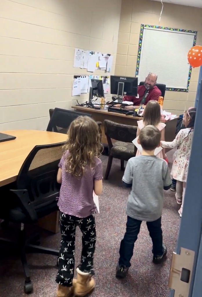 Students surprising Mr. Hamm with balloons and cards