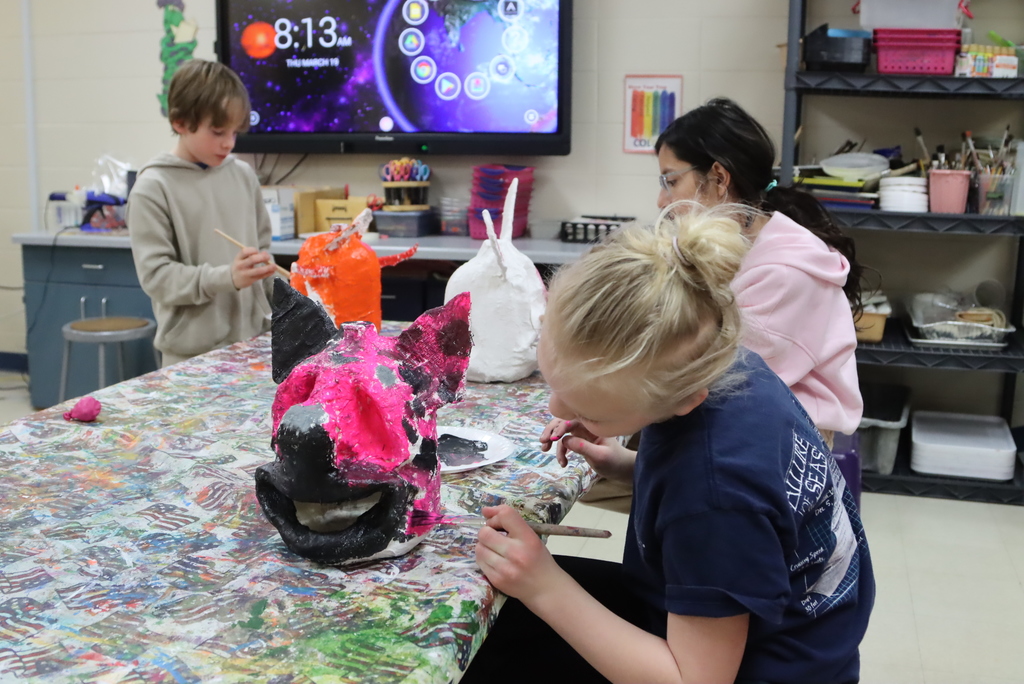 Students working on their paper mache heads in art class (Painting)