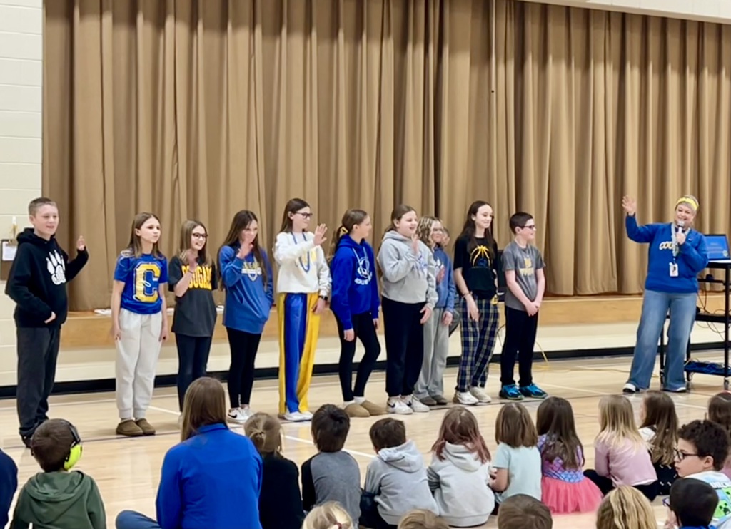 Student council waving to the crowd