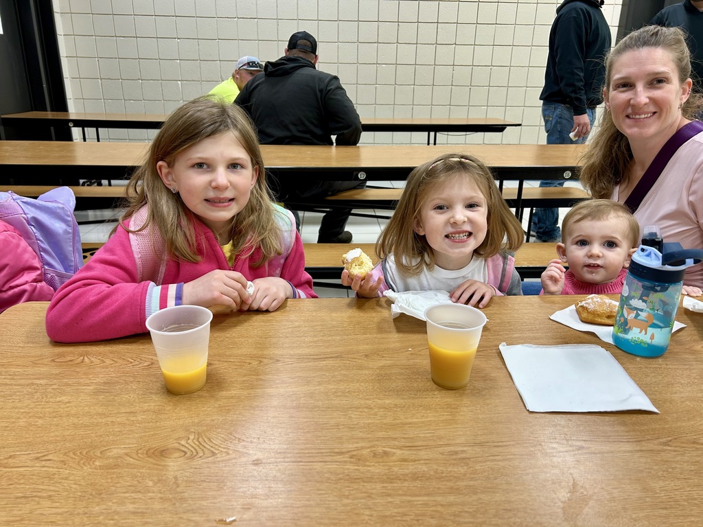 Three sisters and their mom eating donuts