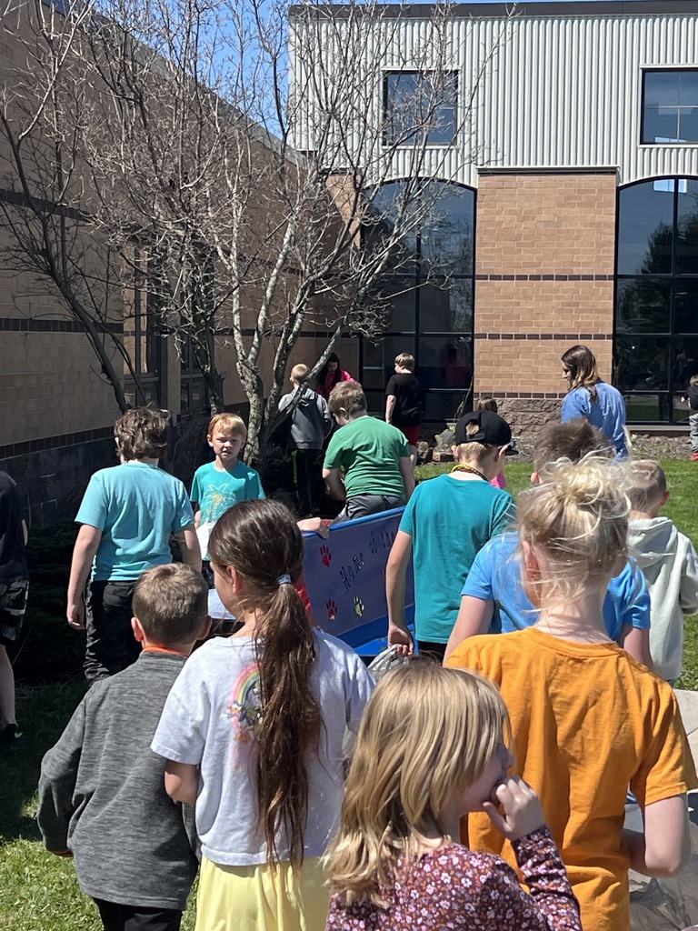 First and 4th graders working together to clean up trash at CES