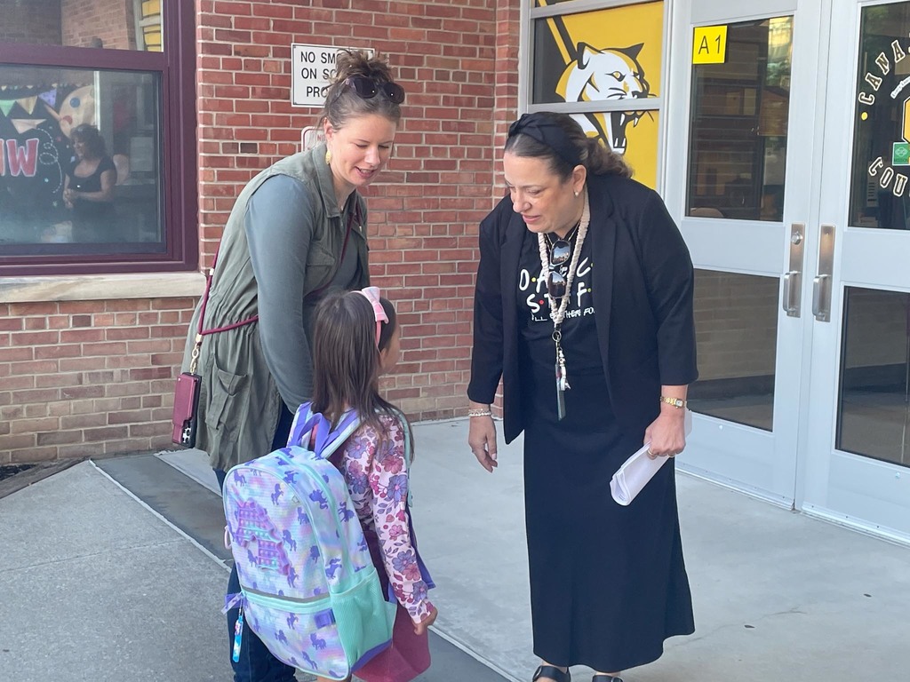 A principal welcomes a student