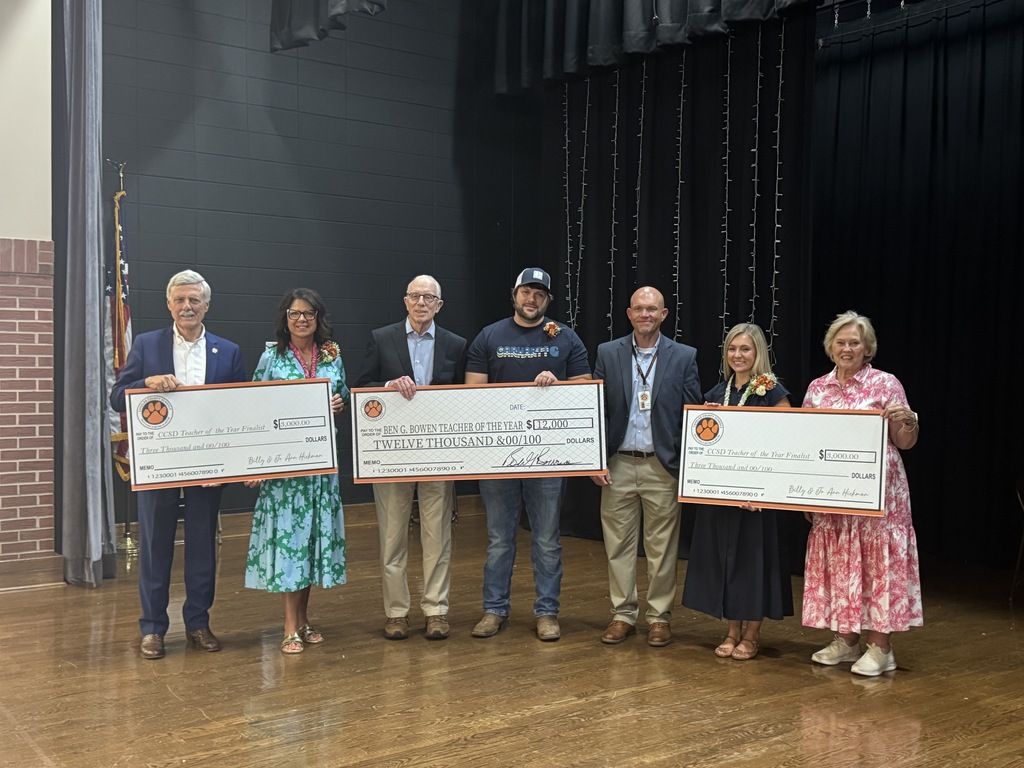 winners and sponsors holding big checks for teachers of the Year