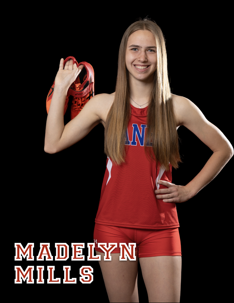 Madelyn Mills holding a pair of shoes behind her shoulder