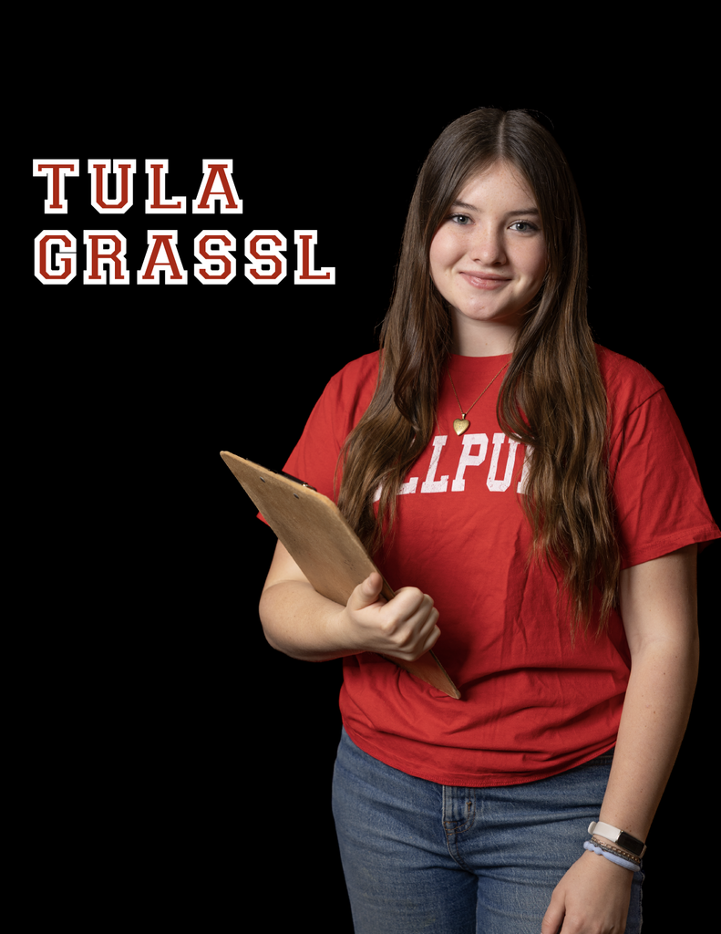 Tula Grassl is the manager and is posed holding a clipboard smiling at the camera