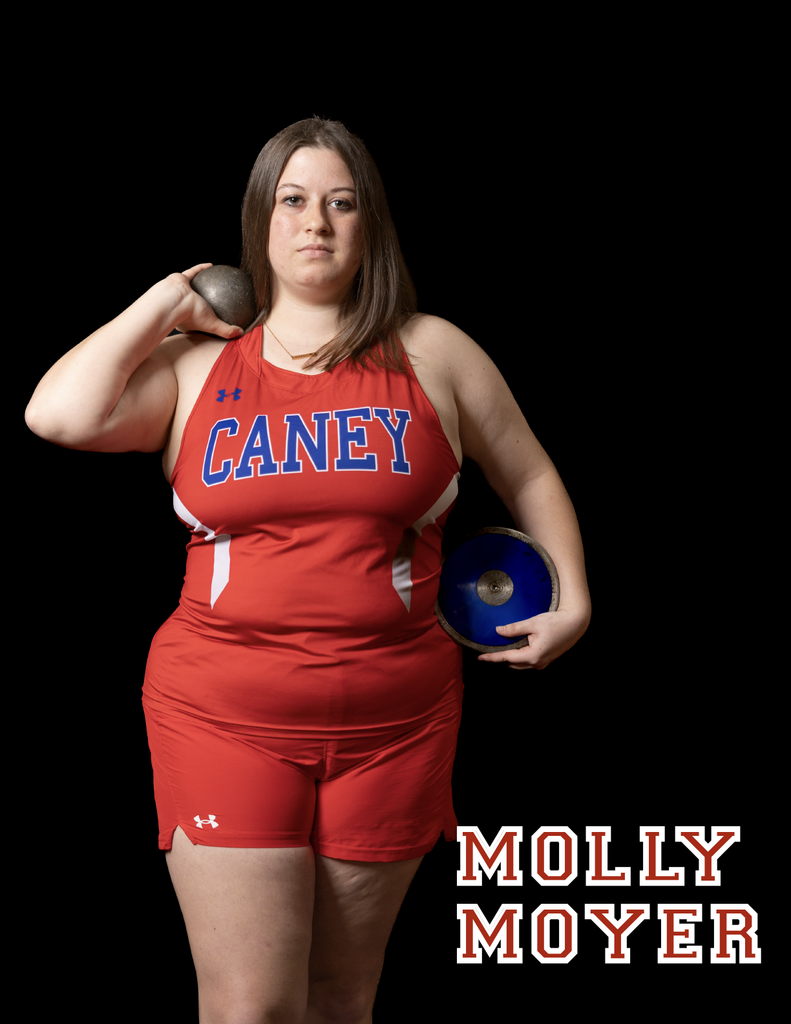 Molly Moyer holding a shot put on one shoulder and the discus down by her hip with the other arm