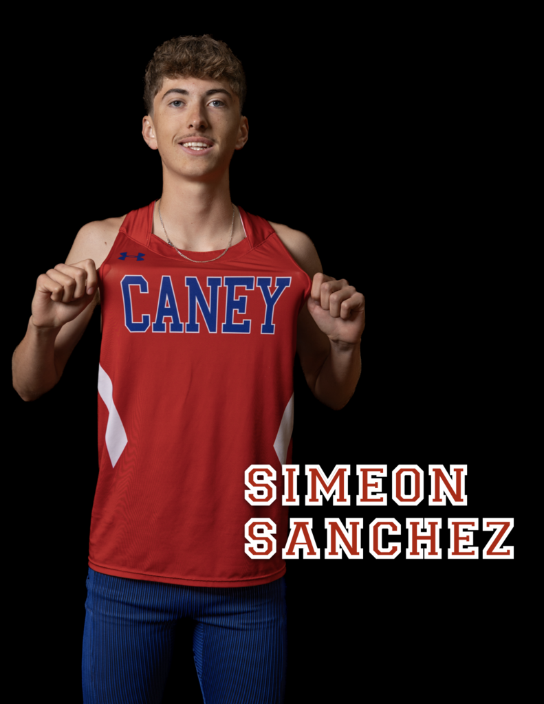 Simeon Sanchez holding jersey out to display the name "Caney" on the chest